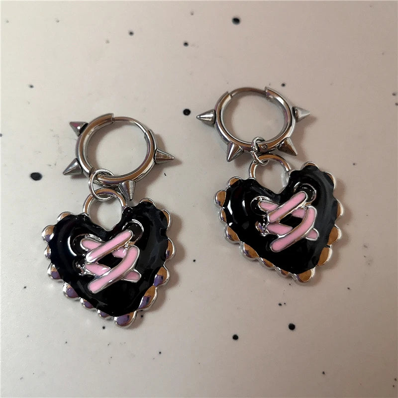 Gothic heart-shaped hoop earrings with intricate lace detailing.