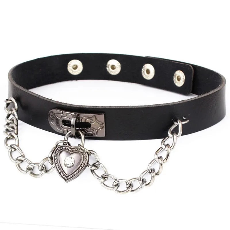 A black choker featuring a laced-up silver heart charm and draped chains.