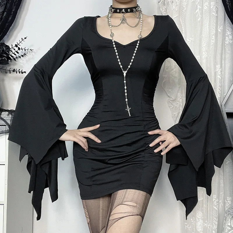 Posing with Midnight Enchantress Batwing Sleeve Mini Dress, highlighting the pleated detailing and flowing sleeves