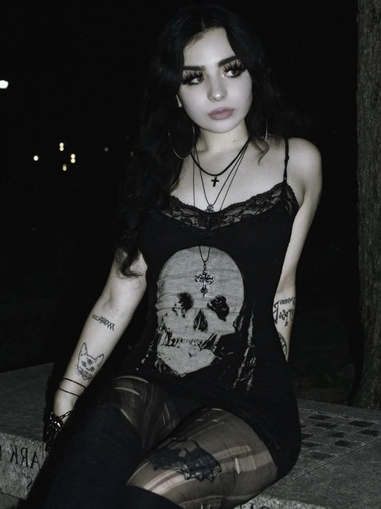 A model wearing the Reaper’s Kiss Mini Dress in an urban gothic setting, wearing leggings.